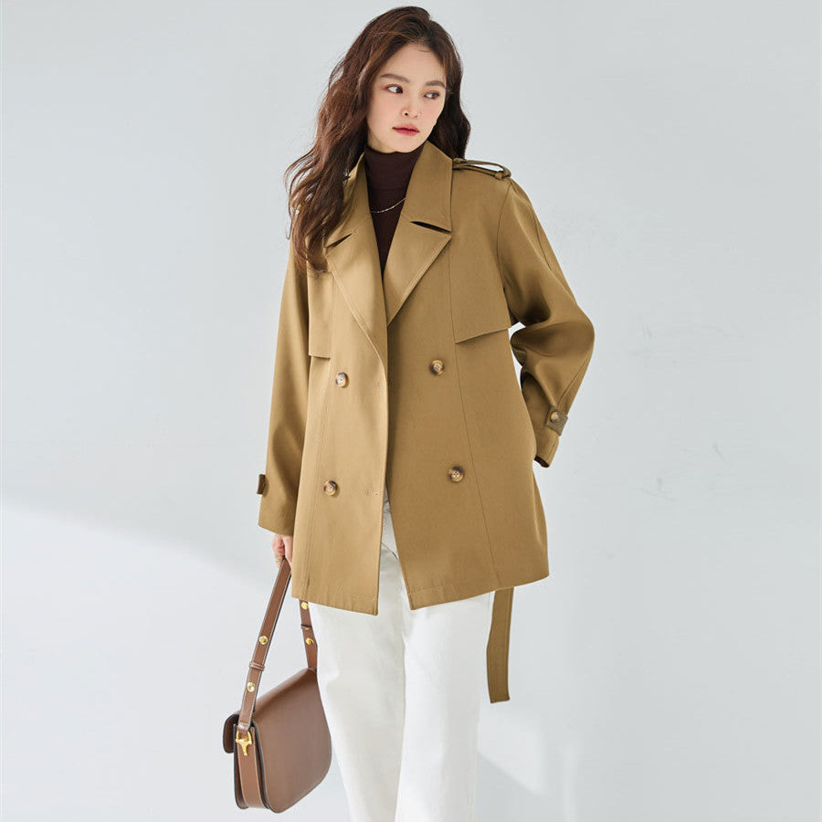 Woman wearing khaki short trench coat with long sleeves
