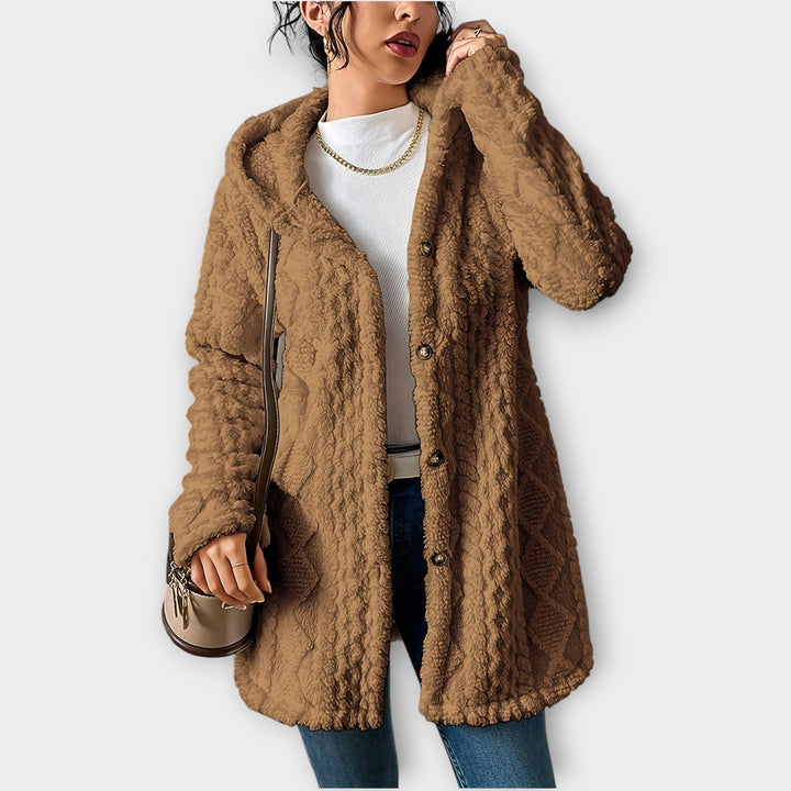 Woman wearing textured hooded winter jacket with relaxed fit