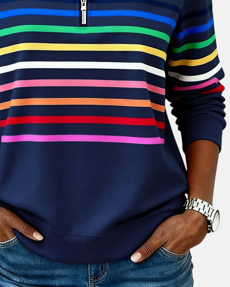 Woman wearing rainbow striped zip sweatshirt with stand collar