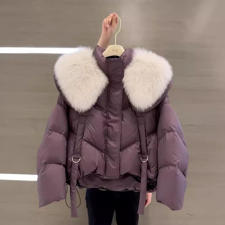 Woman wearing black padded winter coat with fur collar