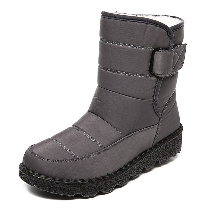 Woman wearing black plush-lined snow boots with buckle