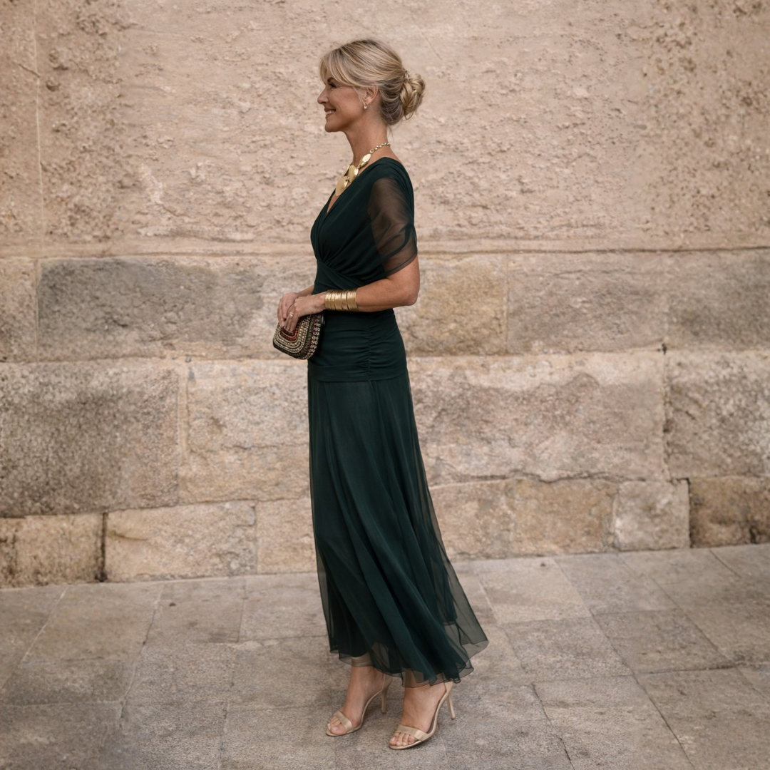 Woman wearing a flowing maxi dress with crossed V-neck