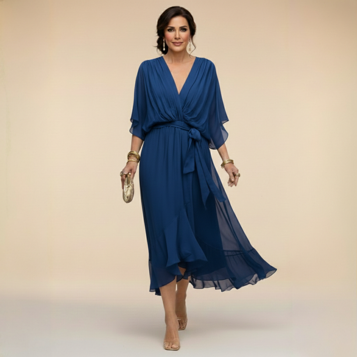 Woman wearing flowy V-neck dress, front view