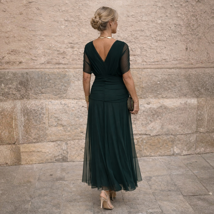 Woman wearing draped maxi dress with deep V-neck