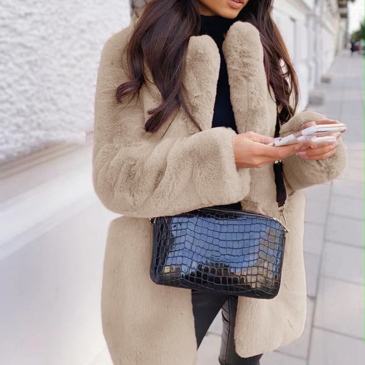 Woman wearing long faux fur coat with lapel collar