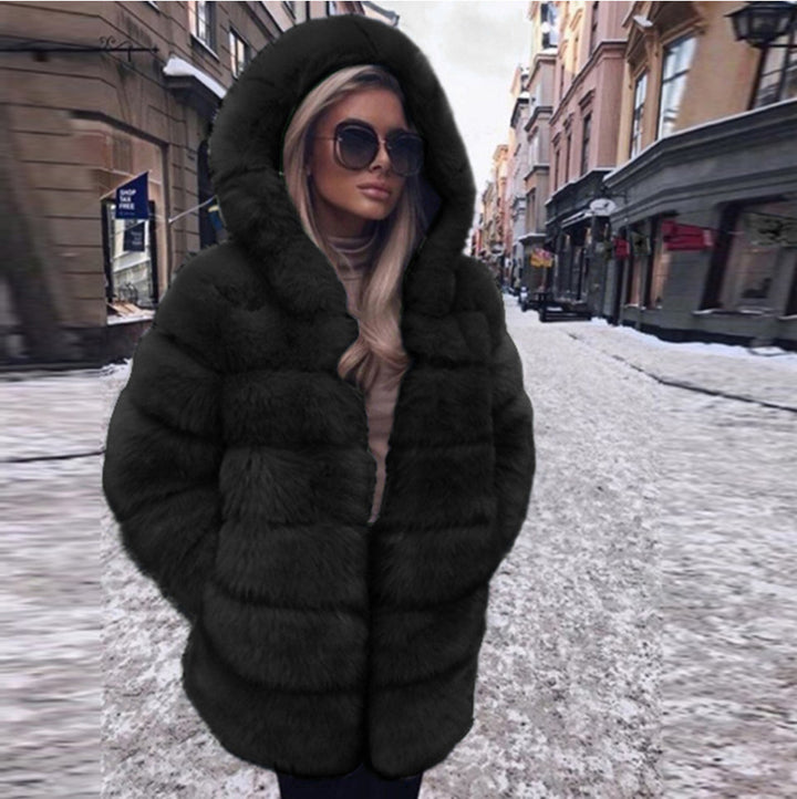 Woman wearing a fluffy faux fur short coat with hood