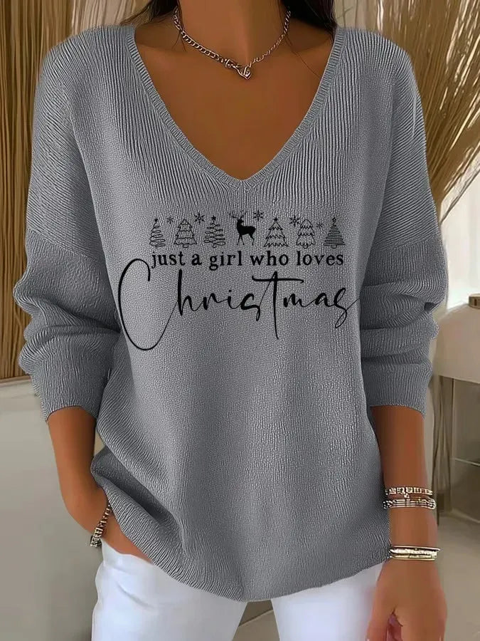 Woman wearing festive V-neck Christmas sweater indoors