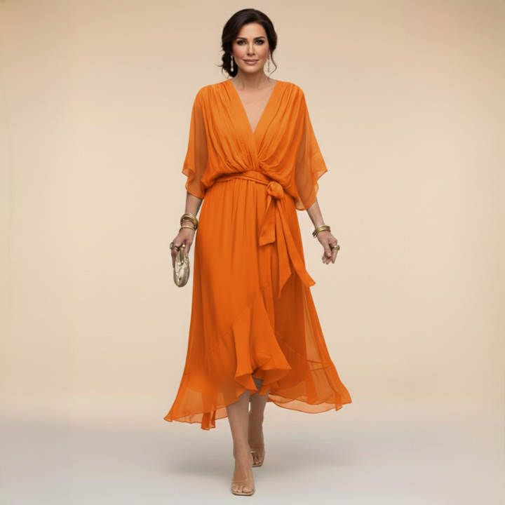 Woman wearing flowy V-neck dress, front view