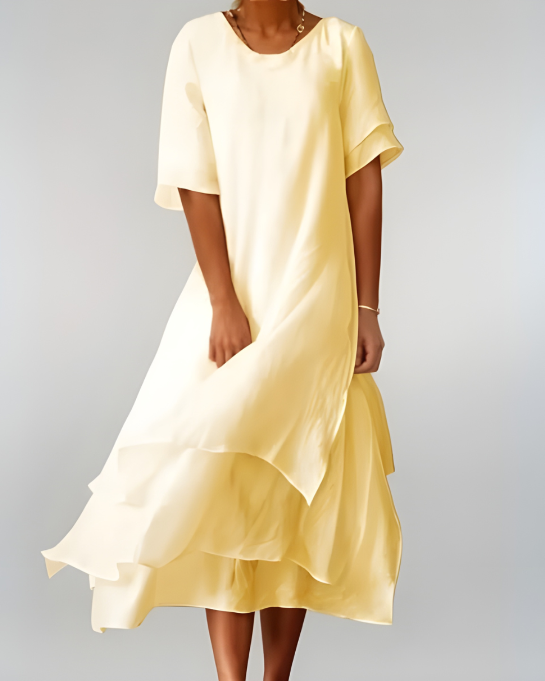 Woman wearing flowing maxi dress with open neckline