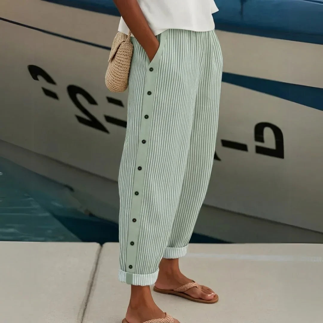 Woman wearing black striped high waisted button pants