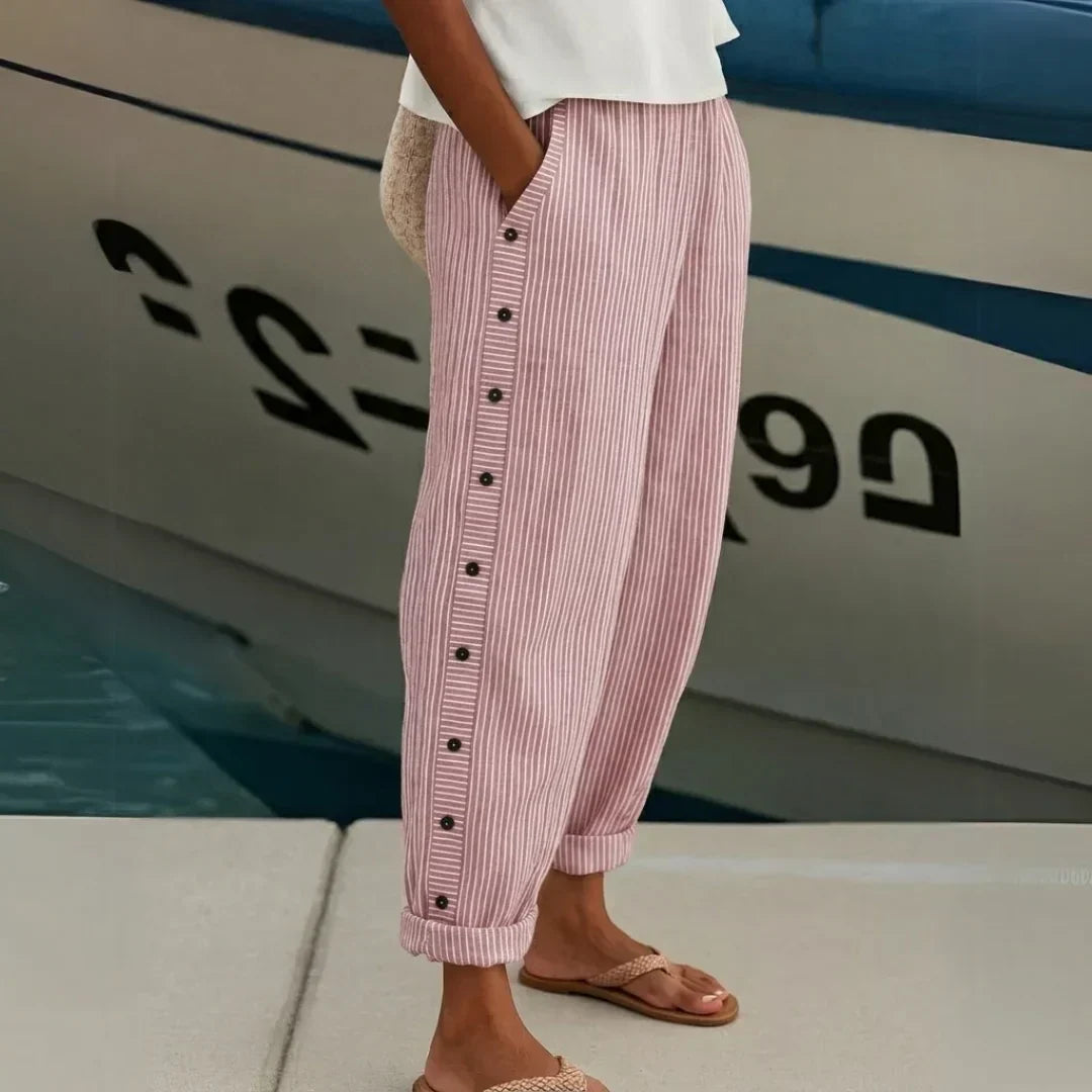 Woman wearing black striped high waisted button pants