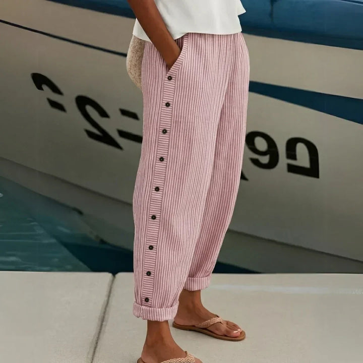 Woman wearing black striped high waisted button pants