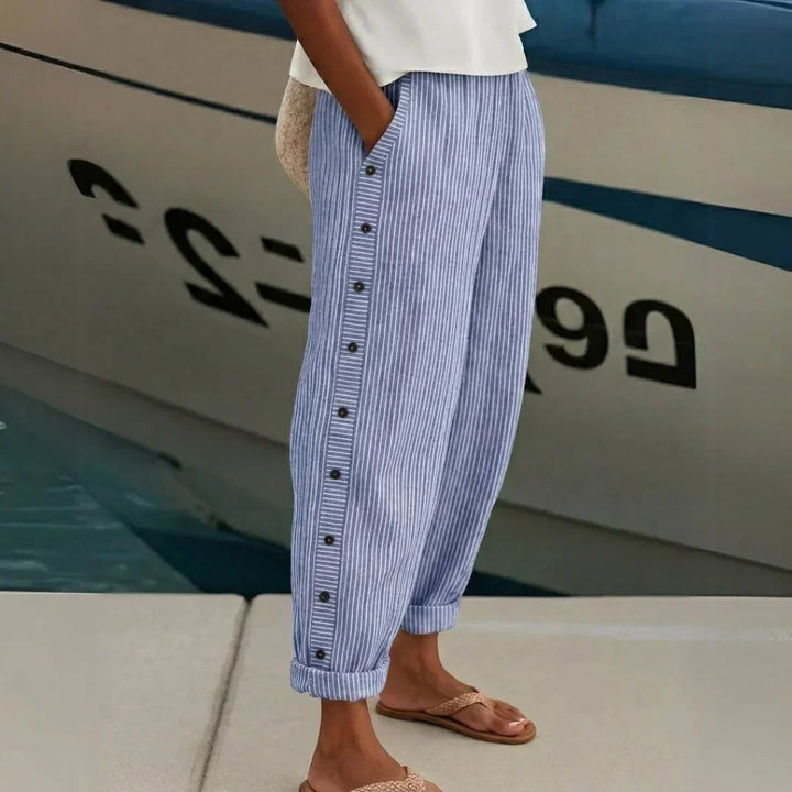 Woman wearing black striped high waisted button pants