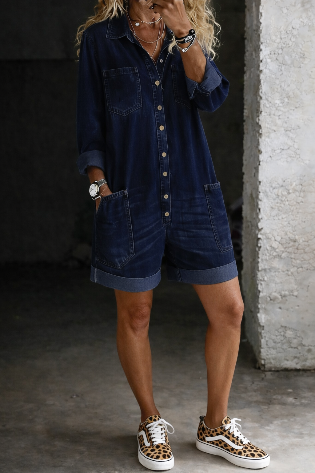Woman wearing short denim jumpsuit with relaxed fit