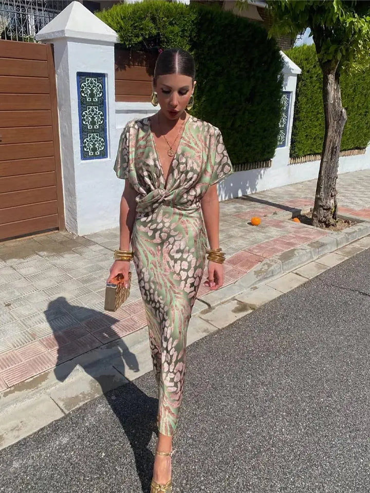 Woman wearing maxi dress with deep V-neck and wrap waist