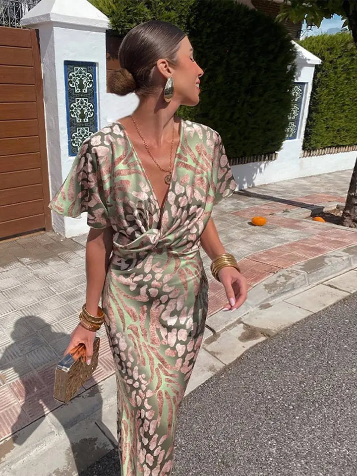 Woman wearing maxi dress with deep V-neck and wrap waist