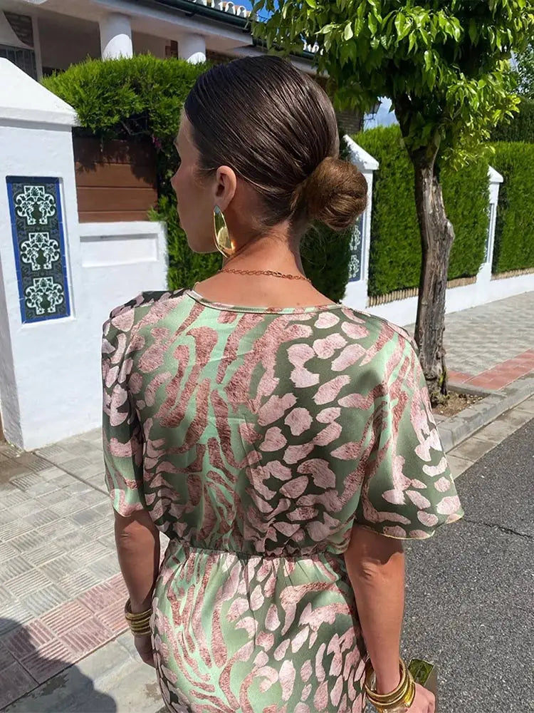 Woman wearing maxi dress with deep V-neck and wrap waist