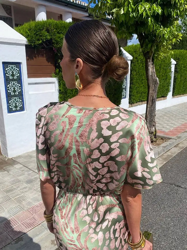 Woman wearing maxi dress with deep V-neck and wrap waist