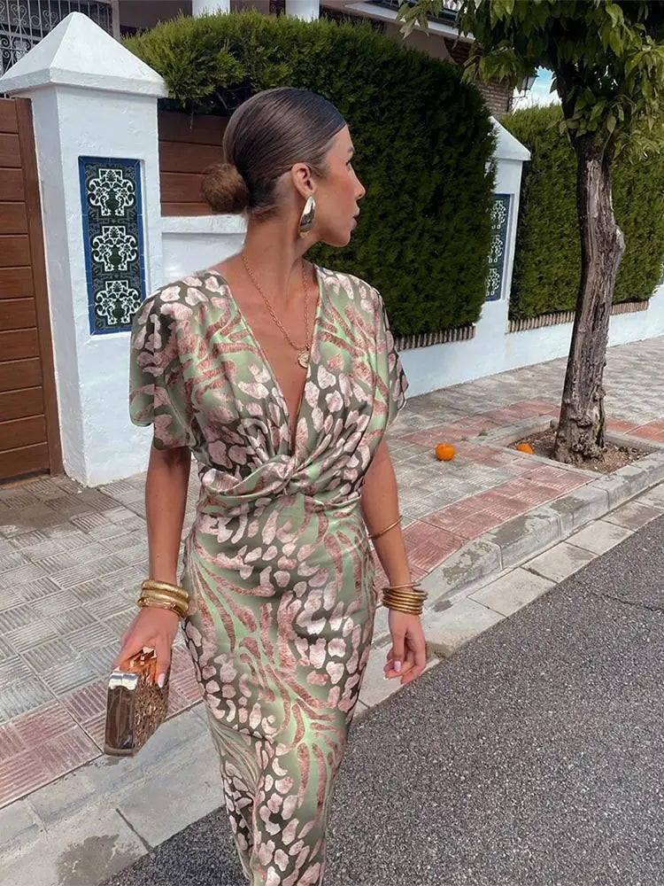 Woman wearing maxi dress with deep V-neck and wrap waist
