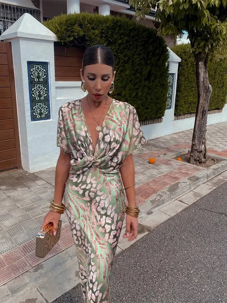 Woman wearing maxi dress with deep V-neck and wrap waist