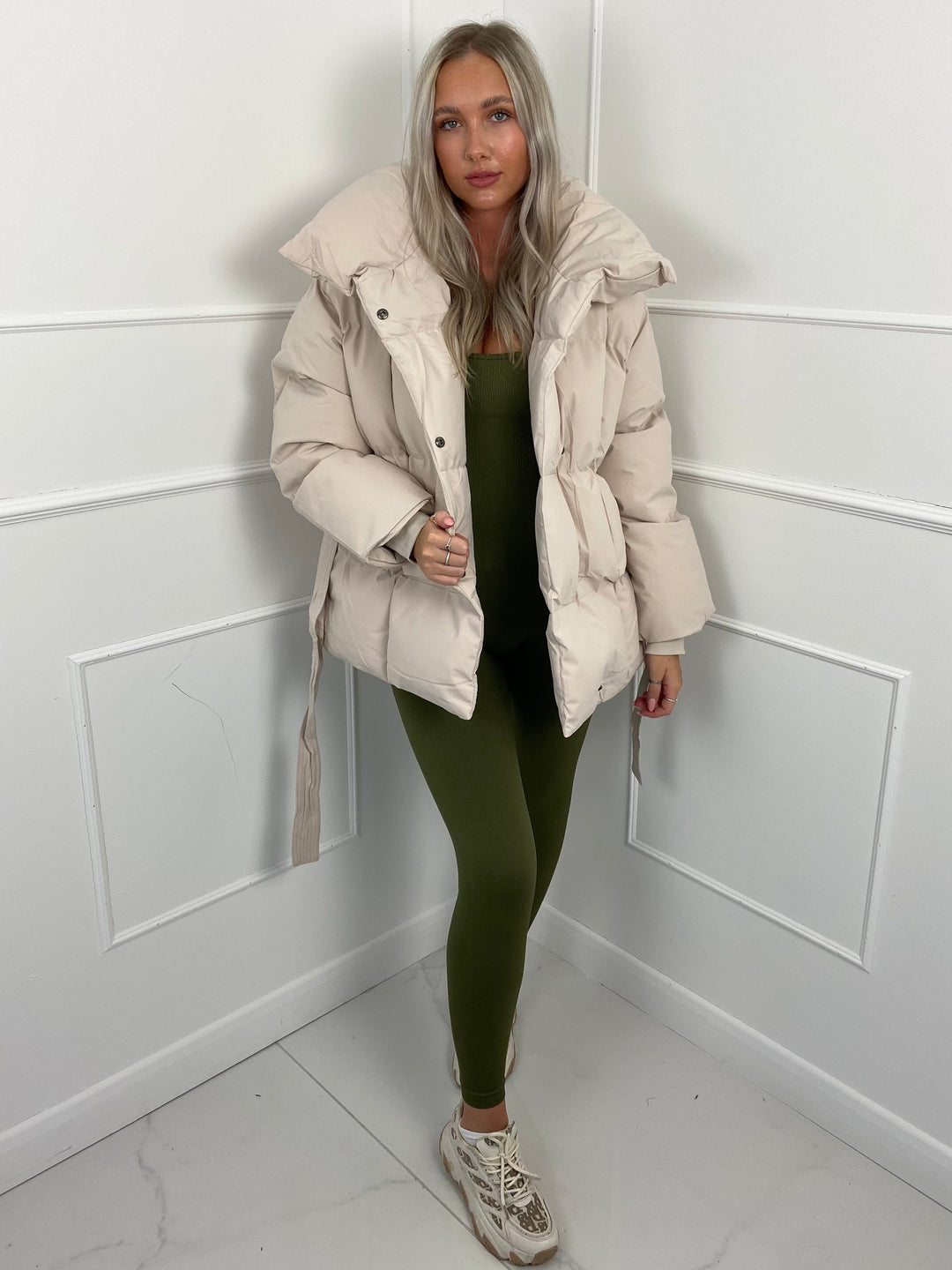 Woman wearing quilted puffer jacket with belt