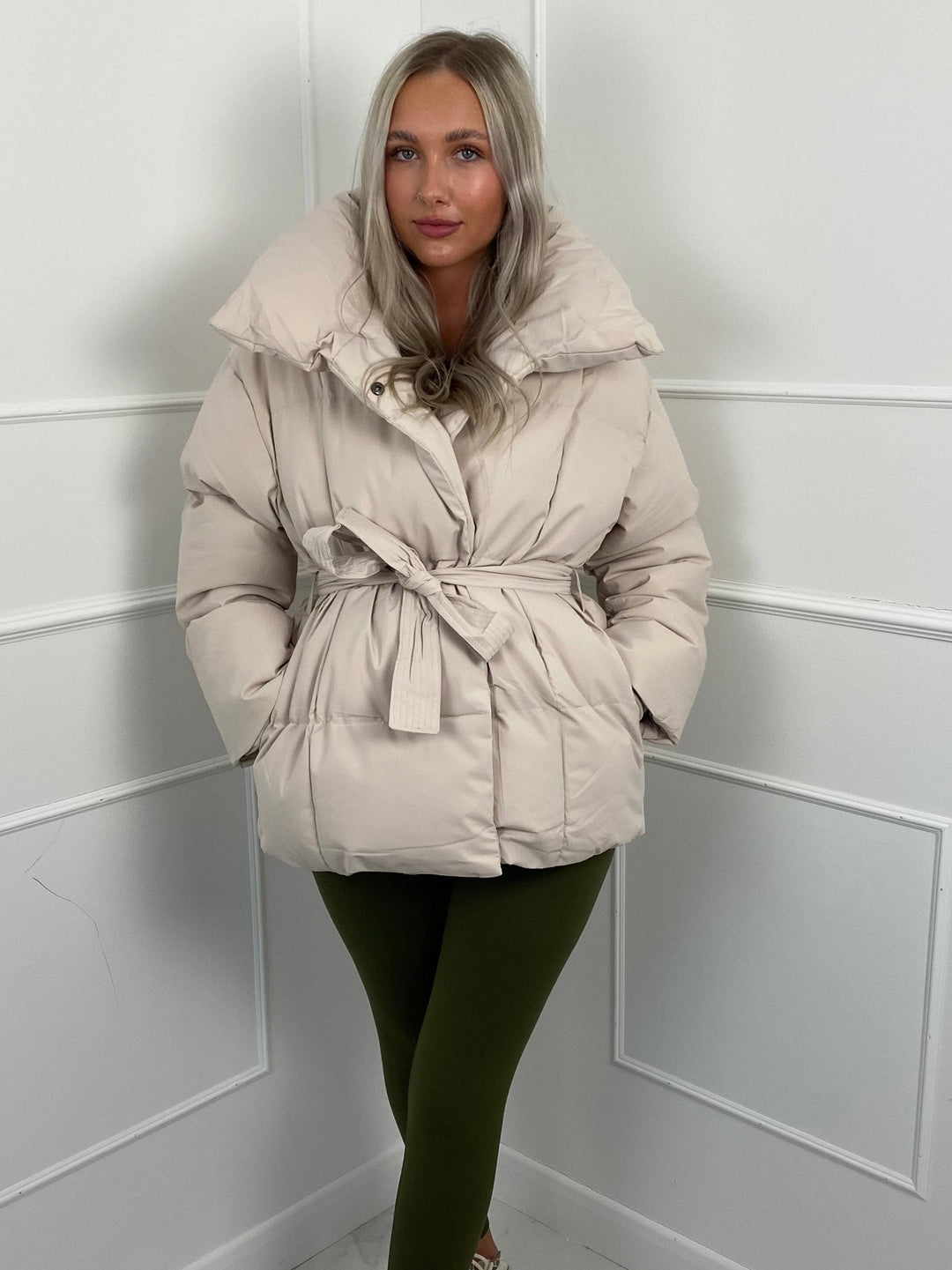 Woman wearing quilted puffer jacket with belt