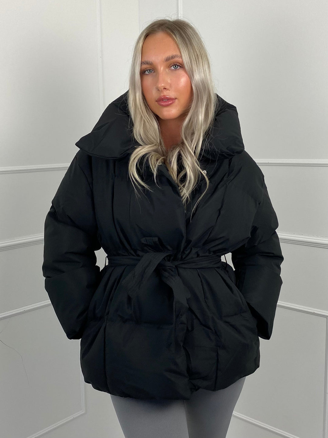 Woman wearing quilted puffer jacket with belt