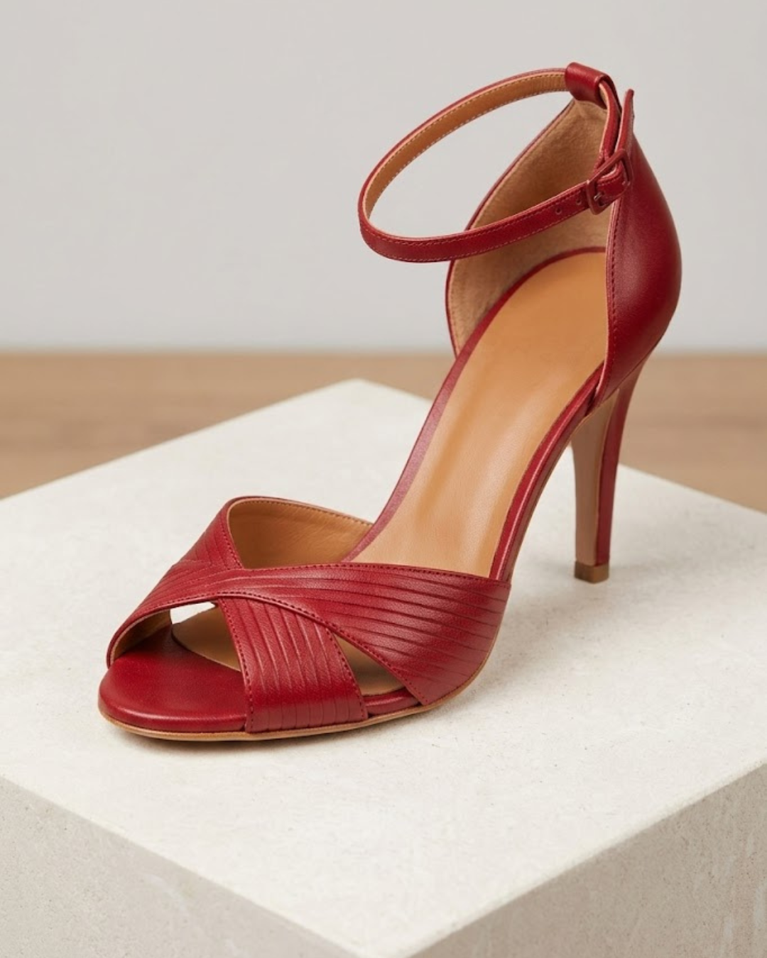 Woman wearing red stiletto heel sandals with braided straps