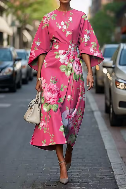 Woman wearing pink and green floral dress outdoors