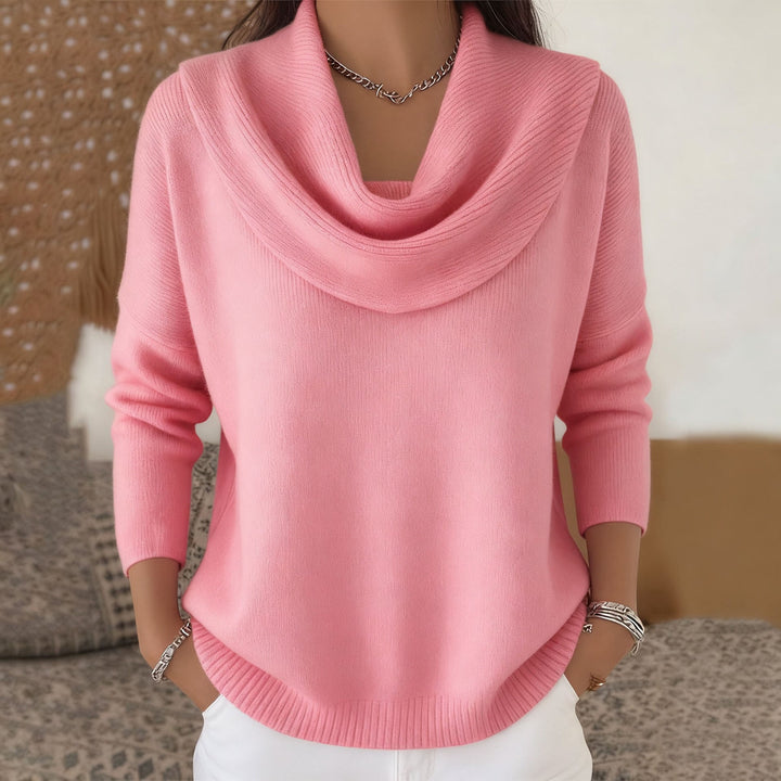 Woman wearing cowl neck knit sweater with ribbed cuffs