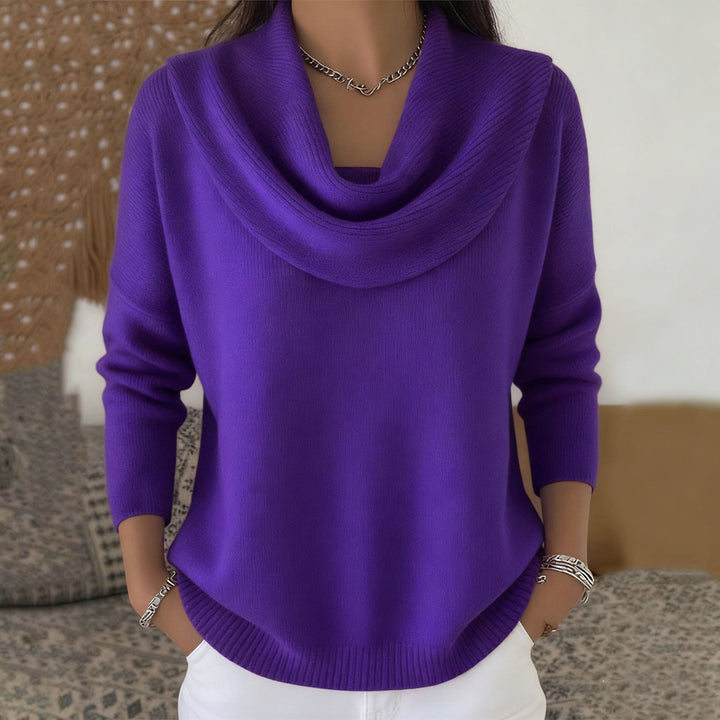 Woman wearing cowl neck knit sweater with ribbed cuffs