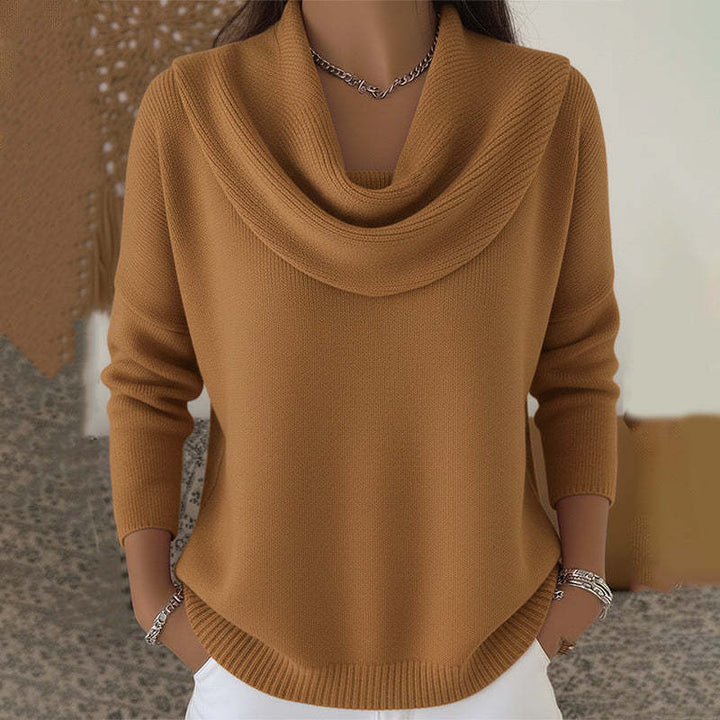 Woman wearing cowl neck knit sweater with ribbed cuffs