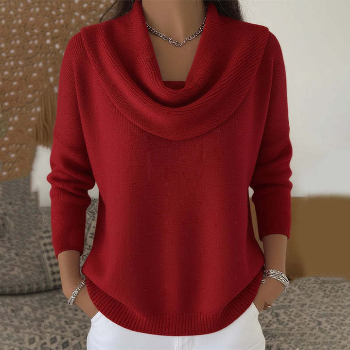 Woman wearing cowl neck knit sweater with ribbed cuffs