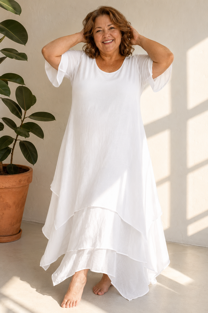 Woman wearing flowing maxi dress with open neckline
