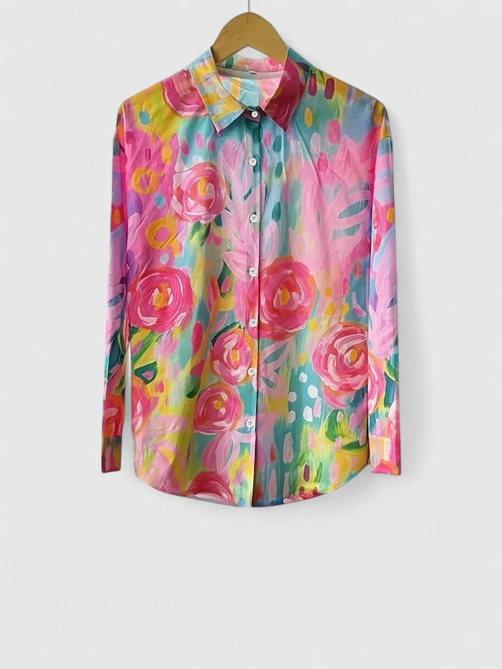Woman wearing artistic print button-up blouse in bright colors