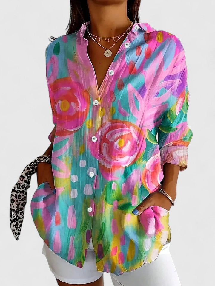 Woman wearing artistic print button-up blouse in bright colors