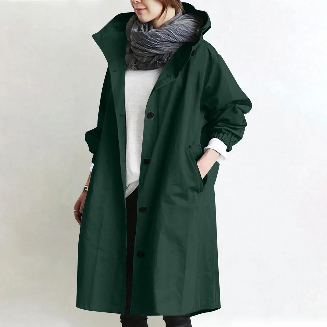 Woman wearing long hooded coat with front buttons