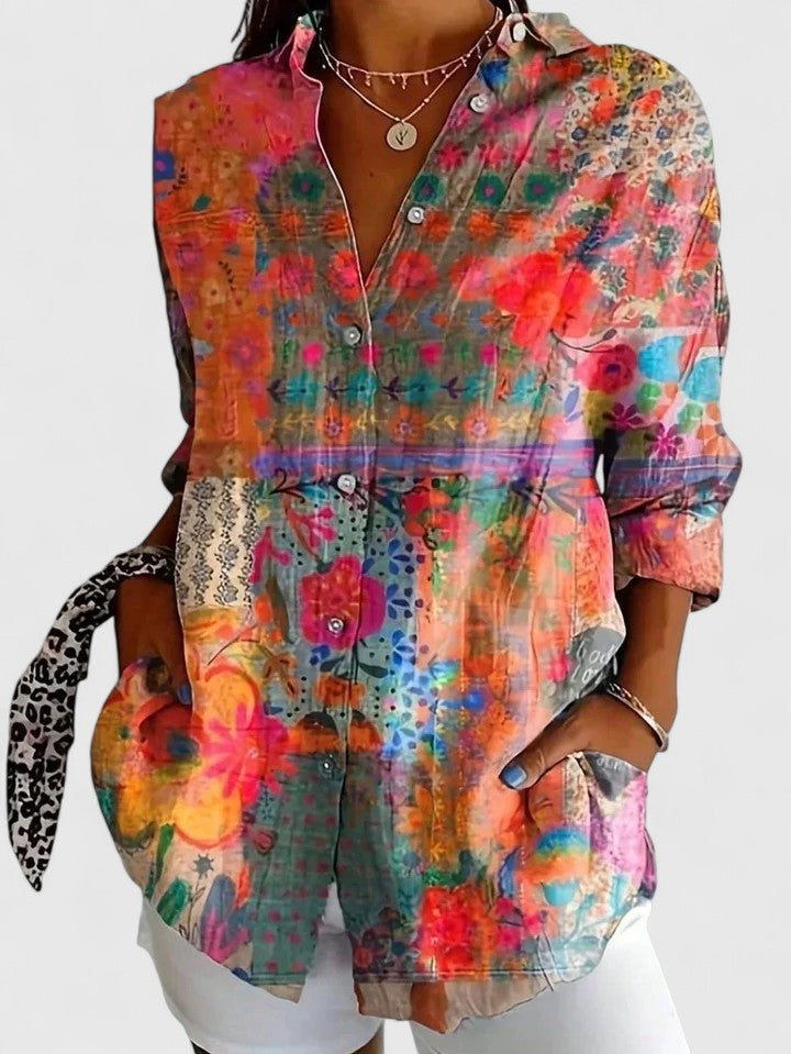Woman wearing artistic print button-up blouse in bright colors