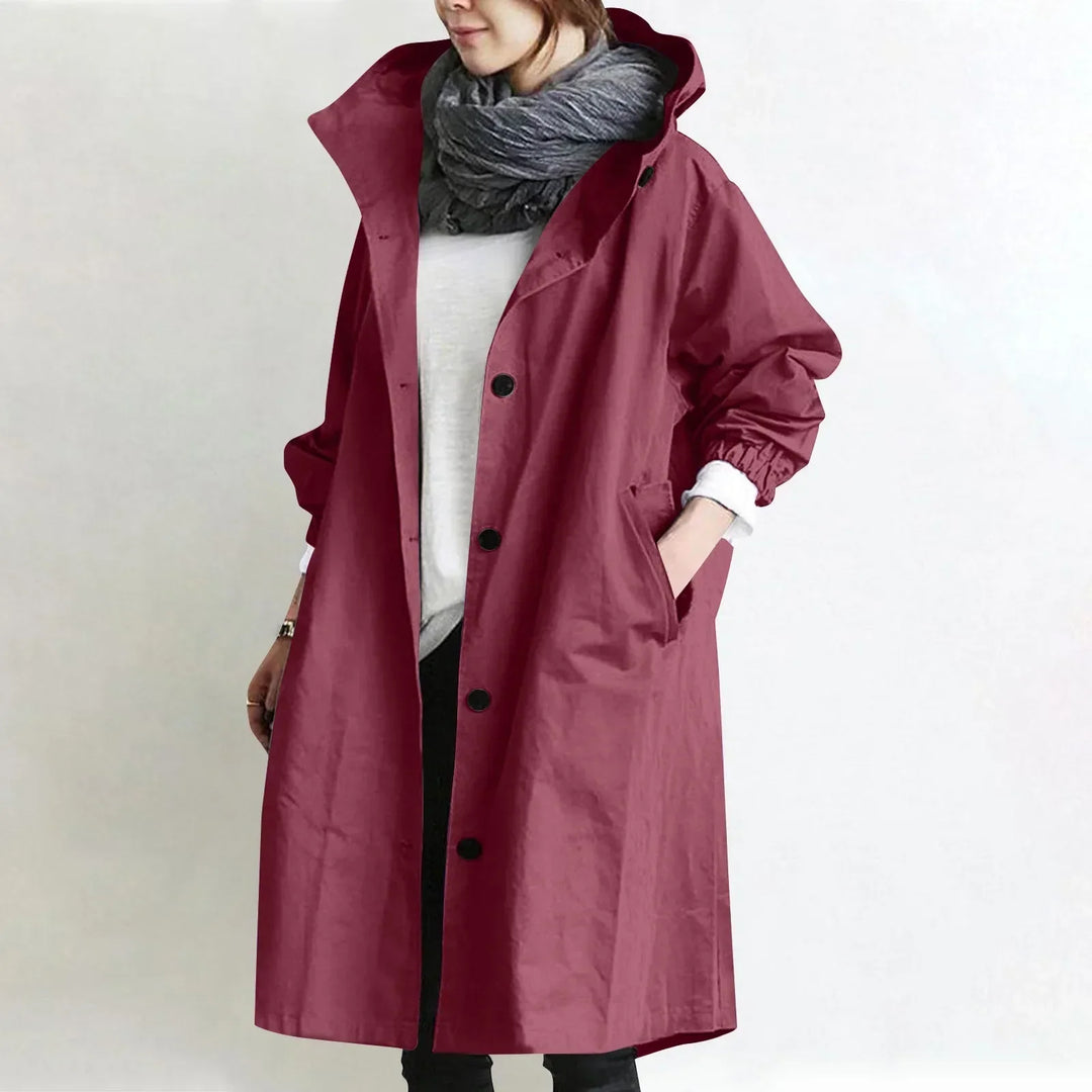 Woman wearing long hooded coat with front buttons