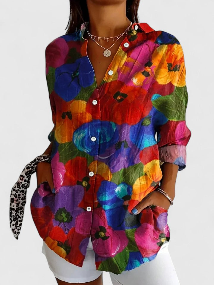 Woman wearing artistic print button-up blouse in bright colors