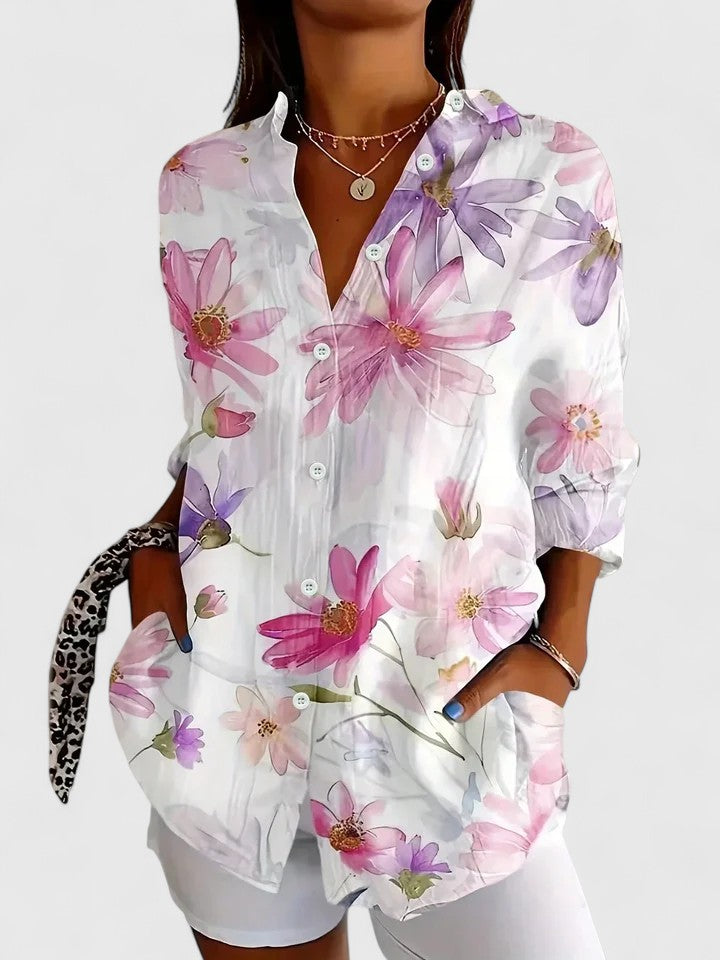 Woman wearing artistic print button-up blouse in bright colors