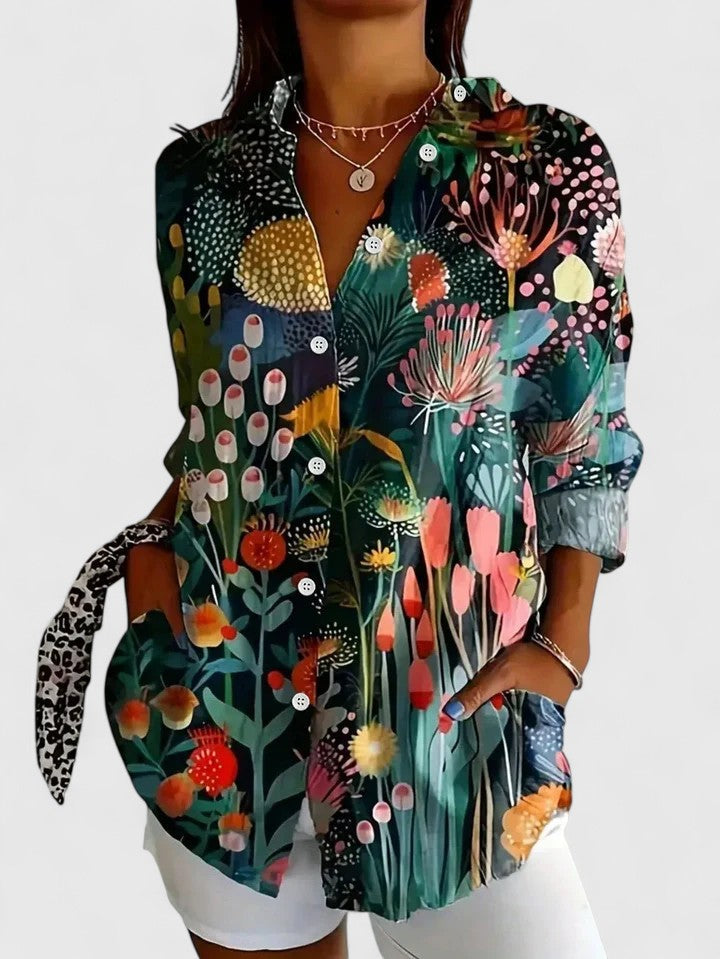 Woman wearing artistic print button-up blouse in bright colors