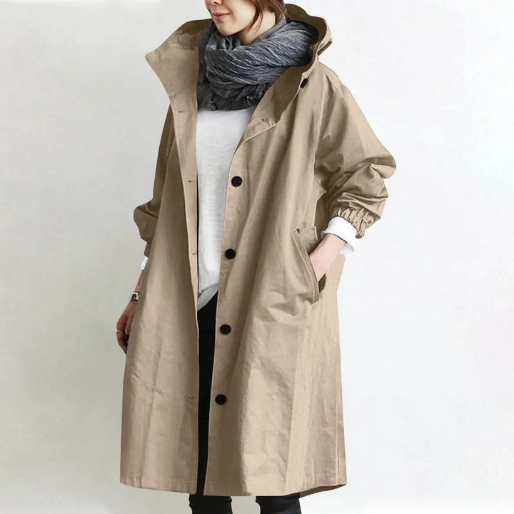 Woman wearing long hooded coat with front buttons