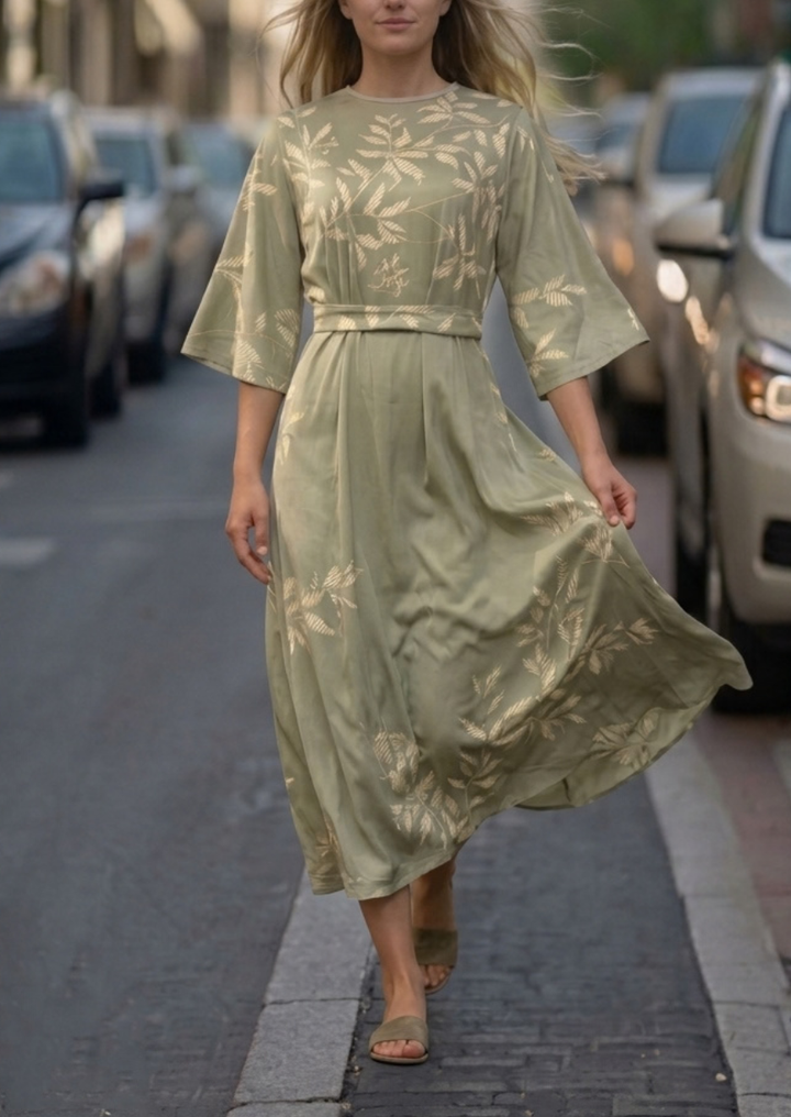 Woman wearing pink and green floral dress outdoors