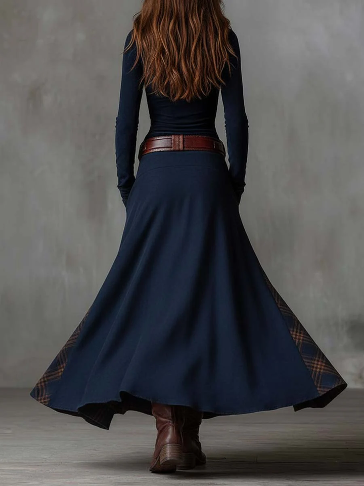 Woman wearing patchwork maxi dress with plaid panels and belt