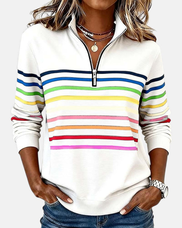 Woman wearing rainbow striped zip sweatshirt with stand collar
