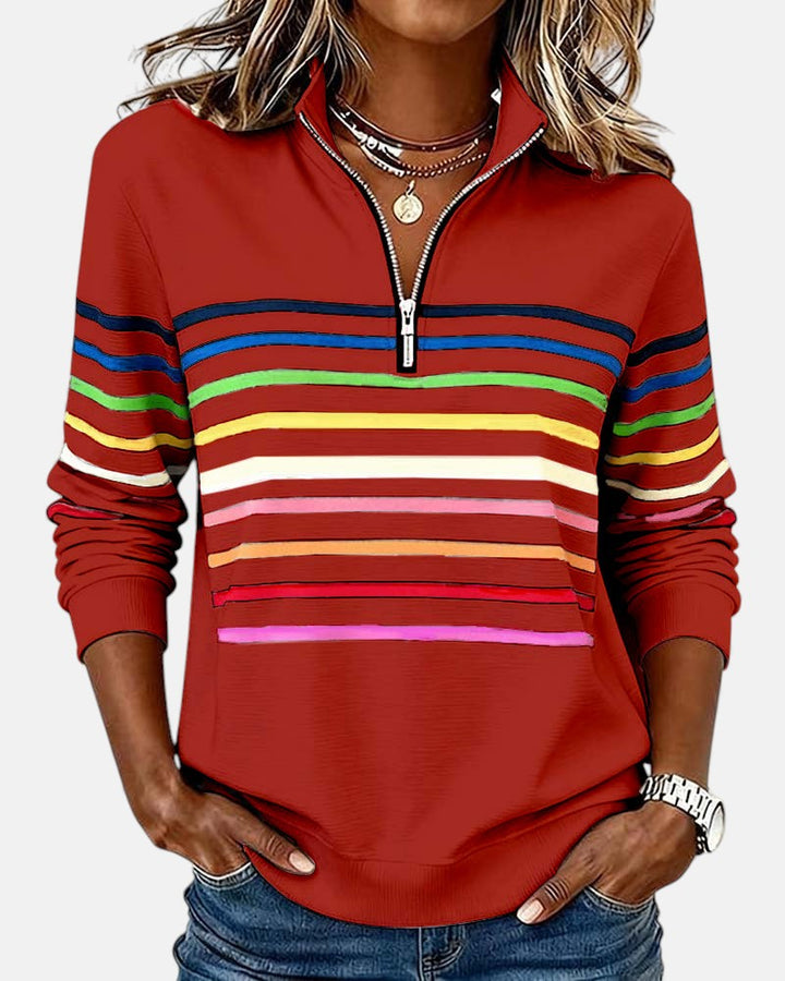 Woman wearing rainbow striped zip sweatshirt with stand collar