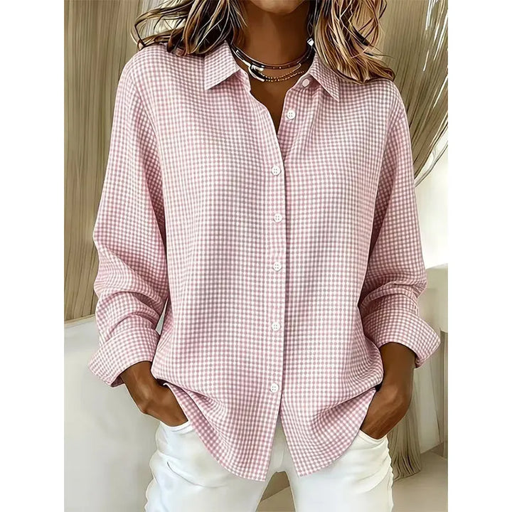 Woman wearing gingham button-up blouse with long sleeves