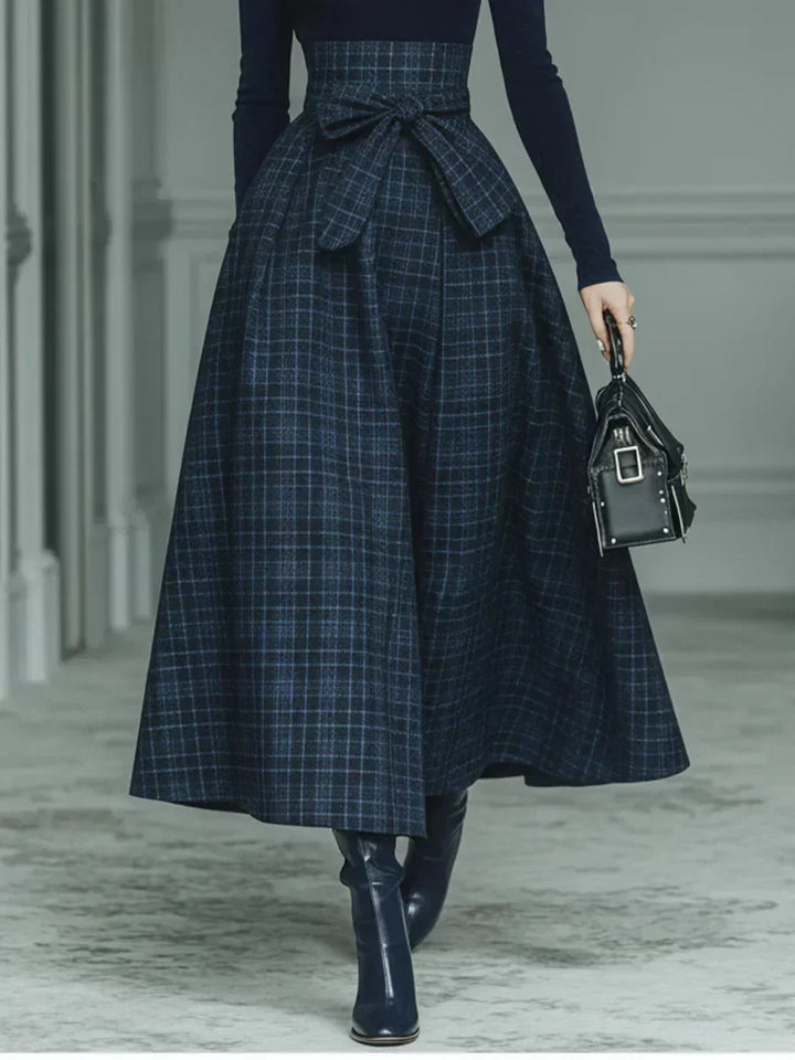 Woman wearing dark blue high-neck top and plaid skirt set