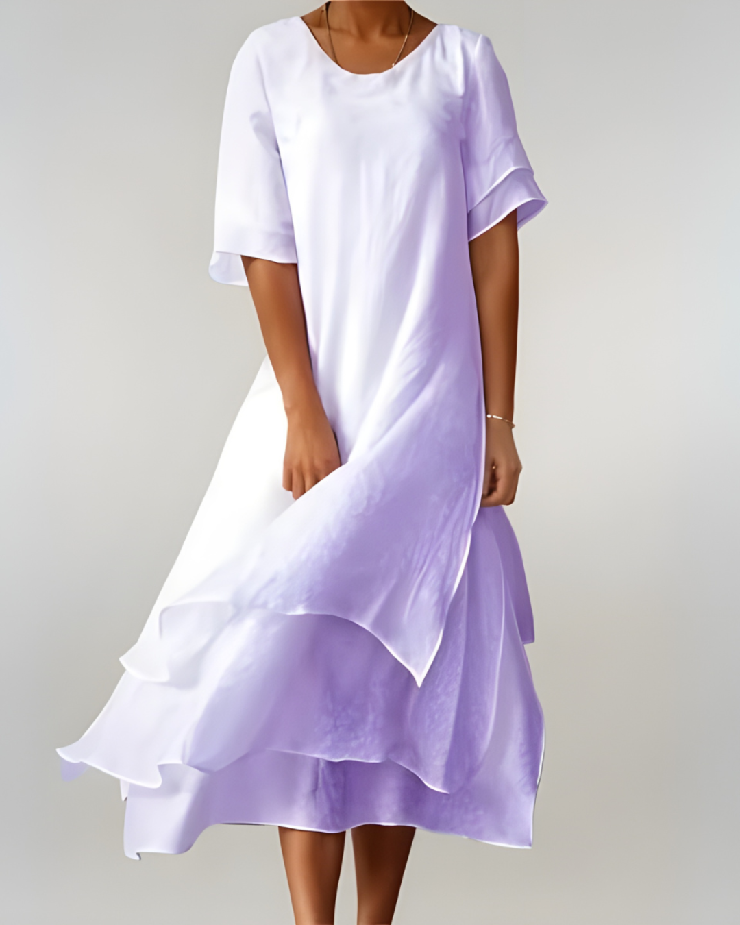 Woman wearing flowing maxi dress with open neckline